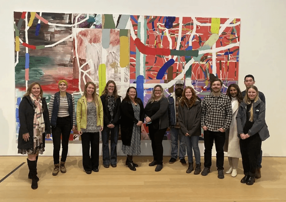 Avesta team on an outing in front of a colourful gallery painting